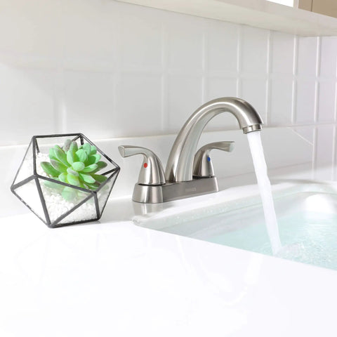 Two Handle Deck Mounted Bathroom Sink Faucet With Brushed Nickel Finish in modern bathroom setting with flowing water