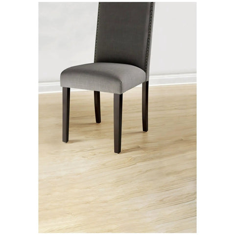 Gray chair on hardwood floor protected by Beige 32 Piece Round One Inch Felt Furniture Pads With Self Stick Adhesive Protect Hardwood Floors From Nicks Dents And Scratches While Moving Furniture Like A Pro.
