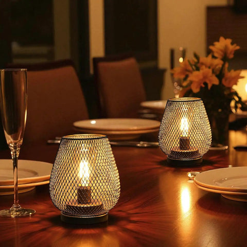 Metal Cage LED Lantern Battery Powered Cordless Accent Light Set Of 2 on dinner table with warm white glow and cozy ambience.