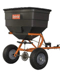 Tow Behind Lawn And Garden Broadcast Spreader With 185 Lb Capacity, showing orange frame and large wheels