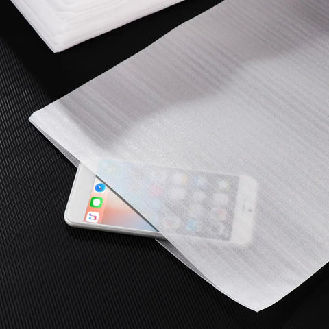 100 Pack White Epe Pearl Foam Pouch Bags For Moving And Shipping Shockproof Cushioning Wrap covering smartphone on black surface