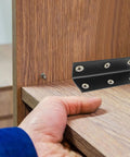Stainless Steel Corner Brackets 4 Pack L Shaped 90 Degree Right Angle Fasteners with Screw Holes on wood furniture in black finish