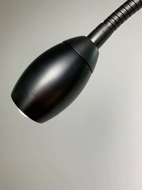Patented Focus Adjustable LED Floor Lamp With Gooseneck No Glare Beam From 3 To 33 Inches At 12 Inches Distance For Reading Crafting And Hobby Projects Low Spill Lighting That Stays Put And Lights Up Your Space, showing close-up of black lamp head and flexible gooseneck.