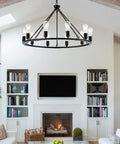 Black Farmhouse Wagon Wheel Chandelier With 10 Lights 31.5 Inch Old School Vintage Industrial Pendant in a living room setting.