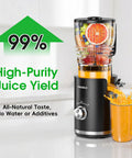 Front view of VMIXBLE black juicer with clear hopper full of fruit; orange juice pours into glass.