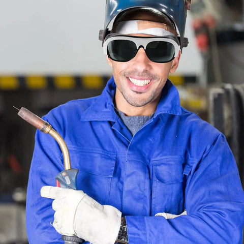 Kickass Welding Safety Glasses Featuring Wide Side Coverage And Mask Compatible Design For Total Eye Protection With Ridiculously Comfortable Fit Guaranteed worn by a smiling welder.