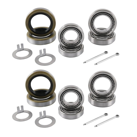 Four trailer axle bearing kits with grease seals, bearings, snap rings, and cotter pins.
