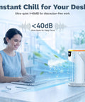 Woman using Evaporative Mini AC Fan With Ice Mist Cooler on desk next to laptop, showing airflow and cooling effect, USB powered.
