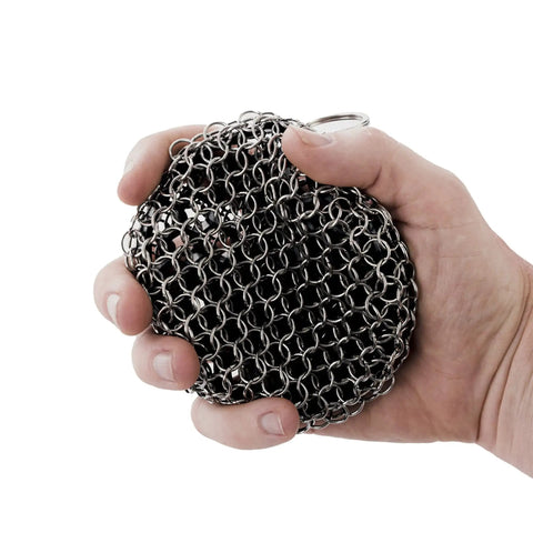Person holding a Cast Iron Scrubber With Stainless Chainmail And Silicone Center, Food Safe And Rust Resistant, 304 Stainless Cleaner.