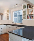 Three Light Kitchen Track Lighting With Modern S Shaped Ceiling Track Bar In Brushed Nickel illuminating a white kitchen space