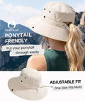 Woman wearing Go To Sun Hat For Women With Ponytail Hole, Wide Brim Beach Bucket Style, Lightweight Nylon, Upf 50 Plus Sun Protection, Outdoor Beige with a view of mountains.