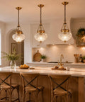 Straight Up Vintage Vibes Handblown Textured Glass Pendant Light With Brushed Antique Brass Finish For Kitchen Island, three fixtures above island.