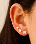 Set Of 6 Extra Long Post Earrings In Rose Gold 316L Stainless Steel Hypoallergenic Cubic Zirconia Ball Studs For Women With Sensitive Ears Lightweight And Water Safe, close-up on ear with 3 CZ studs