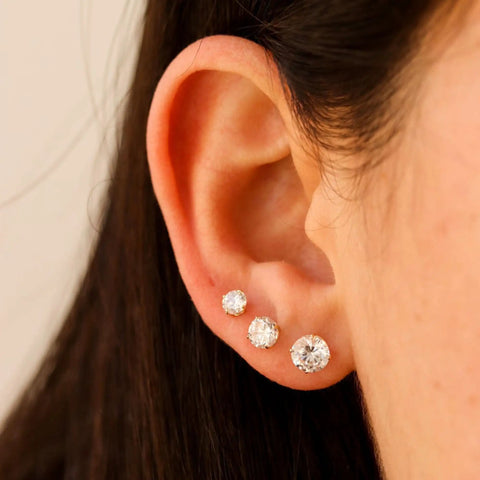 Set Of 6 Extra Long Post Earrings In Rose Gold 316L Stainless Steel Hypoallergenic Cubic Zirconia Ball Studs For Women With Sensitive Ears Lightweight And Water Safe, close-up on ear with 3 CZ studs