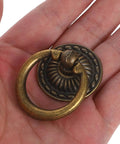 Vintage Ring Pull Handles 8 Pack With Antique Bronze Finish for cabinets drawers dressers in a hand showcasing size and detail.