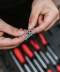 Set Of Twenty M10 Wedge Locking Washers Built Tough With Premium Manganese Steel for automotive applications held in hands.
