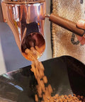Slick Wall Mounted Coffee Bean Dispenser Heavy Duty Pantry Storage Containers With Secure Locking Lids For Kitchen Organization And Bulk Dry Goods Game Changer Black 2 Pack pouring coffee beans into a bowl.