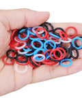 Hand holding 100 Pcs Mixed Color Pigeon Leg Bands for Training Easy Identification And Bird Management Rubber Gentle Fit