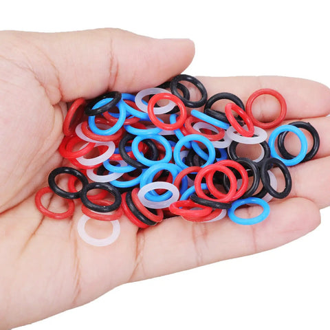 Hand holding 100 Pcs Mixed Color Pigeon Leg Bands for Training Easy Identification And Bird Management Rubber Gentle Fit