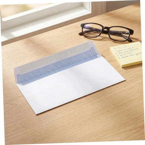 100 Pack White Self Seal Envelopes With Release Paper For Privacy Protection on desk with glasses and notes