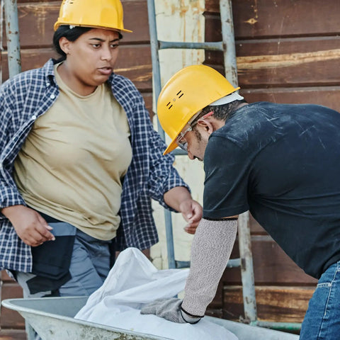 Heavy Duty Cut Resistant Arm Sleeves With Scratch Proof Armor For Gardening And Butchery Tasks Bite Resistant Guards on a worker's arm.