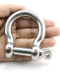 Badass Half Inch Stainless Steel Bow Shackle Screw Pin Anchor held in hand, showcasing heavy duty design for secure connections.