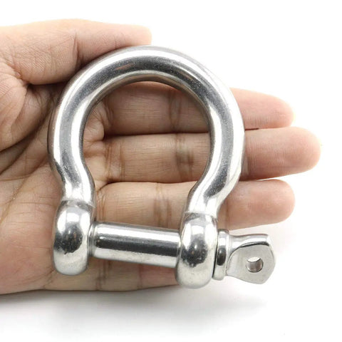 Badass Half Inch Stainless Steel Bow Shackle Screw Pin Anchor held in hand, showcasing heavy duty design for secure connections.