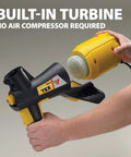 Power Tex Texture Sprayer For Walls And Ceilings With Three Nozzles, Quick Lock N Go being held, built-in turbine visible