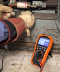 Technician using Digital Auto Ranging Multimeter For AC DC Voltage And Current With Temperature Frequency Capacitance Duty Cycle