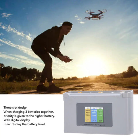 Mini 2Pro Three Channel USB Battery Charger Hub with digital display shown in outdoor drone setup.