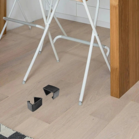Four Pack Outdoor Furniture Clips For Woven Sectionals on floor by chair