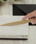 Hand holding a wooden letter opener from Two Pack Wooden Letter Opener Set for Handy Envelope Slitter For Quick Mail Openings