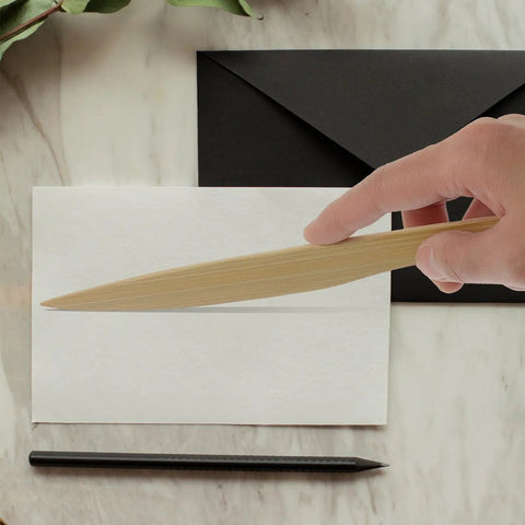 Hand holding a wooden letter opener from Two Pack Wooden Letter Opener Set for Handy Envelope Slitter For Quick Mail Openings