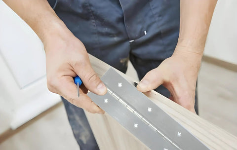 Installation of Heavy Duty 6 Inch Silver Stainless Steel Piano Hinges Two Pack on a wooden frame with screws.