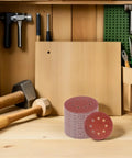 Assorted 8 Inch Hook And Loop Sanding Discs With Center Hole For Wood Metal And Plastic Grit Grinders, displayed with tools in a workshop.