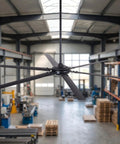 Massive 120 Inch Industrial Black Ceiling Fan With No Lights Ultra High Airflow 36000 CFM for shops, garages, barns, in warehouse setting.