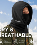 Man wearing Balaclava Ski Face Mask With Windproof Thermal Comfort For Men And Women Convertible Hood Full Head Cover Scarf Neck Gaiter For Cold Weather Black Stay Toasty in black standing outdoors against blue sky background.