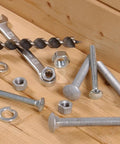 Workhorse Carriage Bolts 3/8 By 5 1/2 Inch Zinc Plated Steel fasteners, assorted nuts, and tools on wood surface.