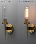 Slick Antique Brass One Light Bathroom Vanity Wall Sconce With Two Point Eight Inch Cylinder Ribbed Clear Glass Canopy, light on and off