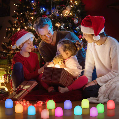 Family enjoying Color Changing Mini LED Night Light 7 Color Rainbow Mood Lighting Cordless Battery Powered Pack Of 12 under Christmas tree