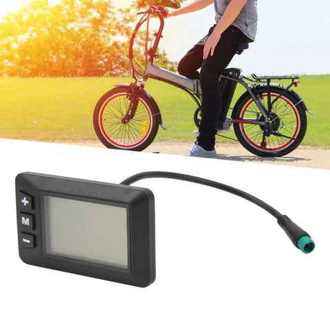 36V Electric Bike LCD Display Panel With 5 Pin Waterproof Interface, nearby a man with a foldable bike outdoors
