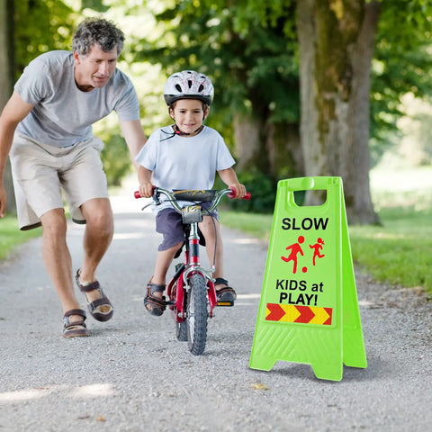 Slow Kids At Play Signs For Street Double Sided With Reflective Tape High Visibility Children At Play Safety Sign For Neighborhoods Schools Parks Sidewalks And Driveways 2 Pack Green next to child learning to bike
