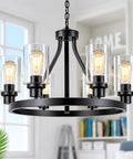 Six Light Farmhouse Wagon Wheel Chandelier for Dining Room and Kitchen Island Pendant Lights in Modern Black Industrial Rustic Metal With Adjustable Height and UL Certified Wiring for a Cool Slick Modern Vibe hanging indoors.