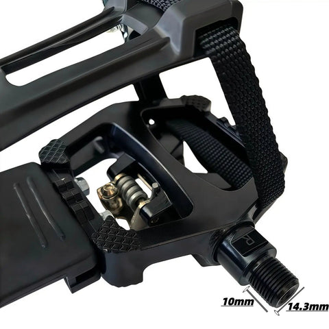 Close-up of dual sided SPD clipless pedals with toe clip straps for indoor cycling, showing universal nine sixteenth inch axle.