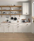 Modern kitchen with matte black and gold T bar cabinet knobs on white cabinets and open wooden shelves