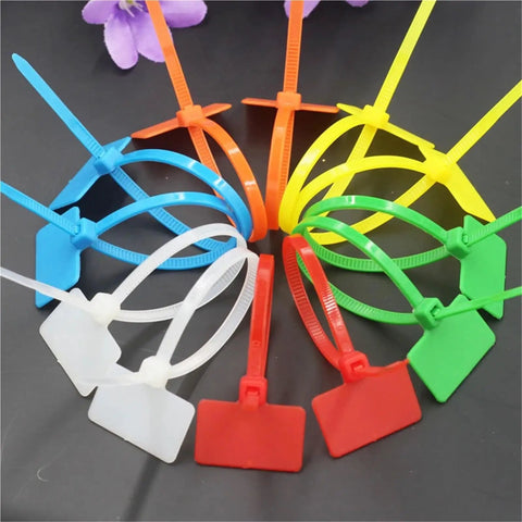 Rock Solid 100 Pack Nylon Self Locking Cable Ties With Write On Labels in assorted colors arranged for easy identification.
