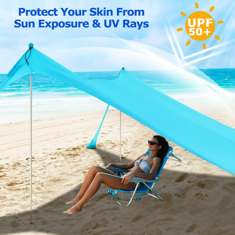 Beach Tent Sun Shelter 10x10ft Pop Up Canopy With UPF50 Plus Shade on a sunny beach, sheltering a person, with windproof poles.