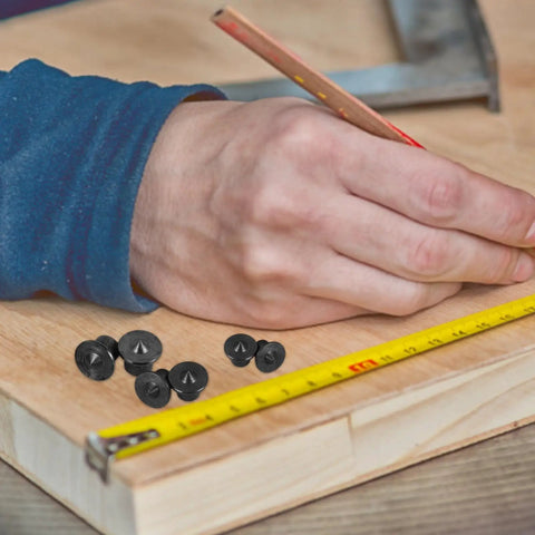 Person marking wood with pencil and tape measure next to 8 Piece Pro Grade Woodworking Dowel And Tenon Center Transfer Pins Drill Guide Set