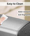 Hand cleaning Slim Swing-Top Rectangular Trash Can 8L Stainless Steel with water droplets showing water-resistant feature.