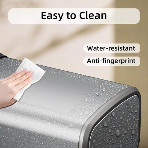 Hand cleaning Slim Swing-Top Rectangular Trash Can 8L Stainless Steel with water droplets showing water-resistant feature.